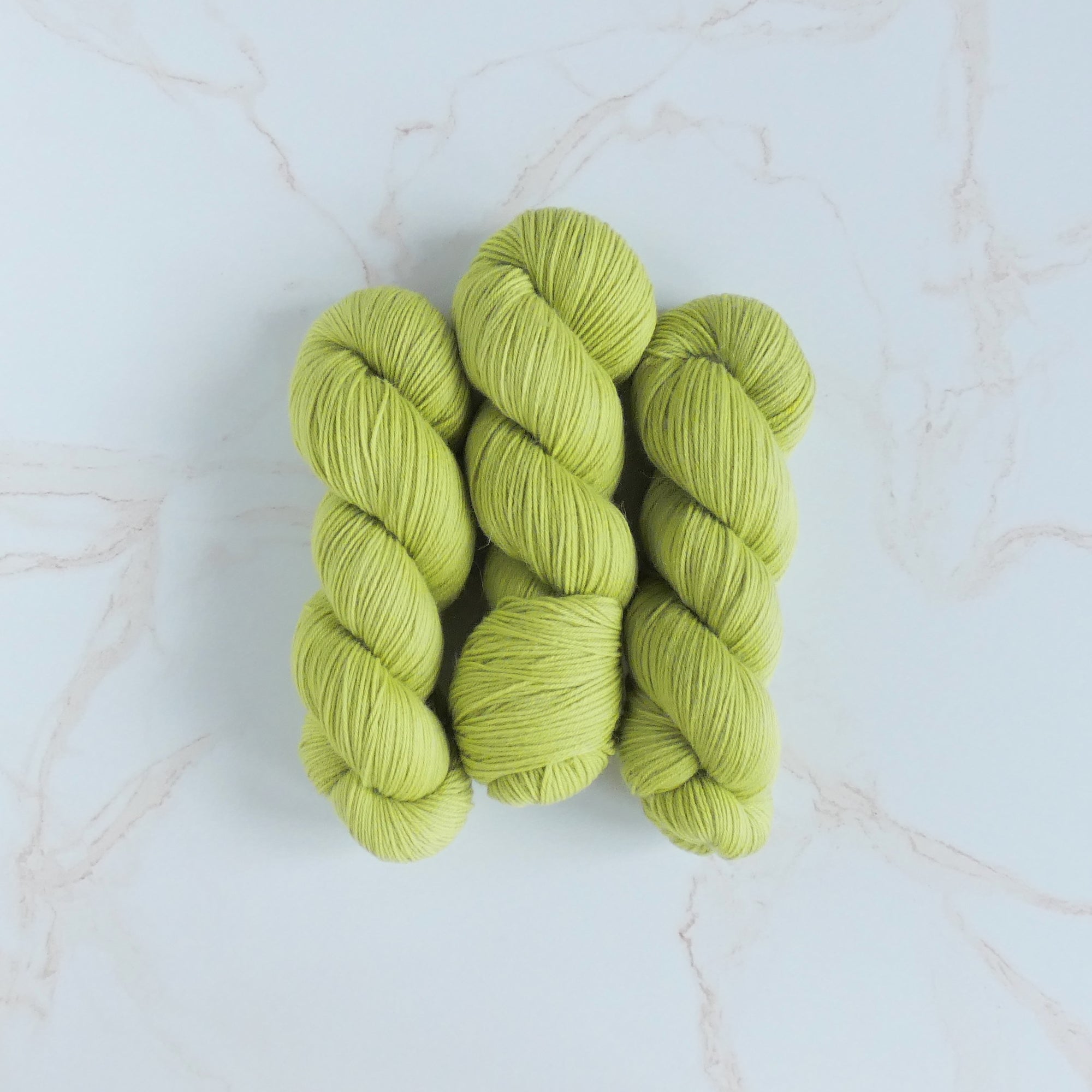 The Wandering Flock Baby Paca Yarn - Neon Lilac Colorway, made from 50% Extra Fine Merino, 30% Baby Alpaca, and 20% Nylon, offering a high twist 4-ply structure, perfect for Lite Sport or fat fingering substitute.