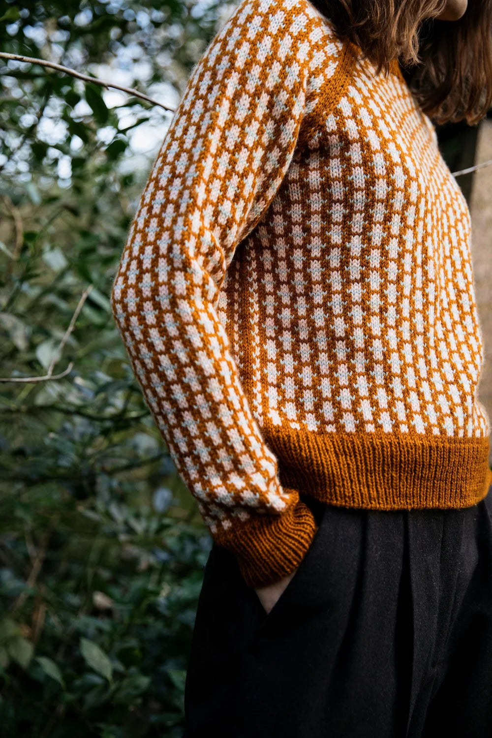 Person wearing a colorwork knit sweater.
