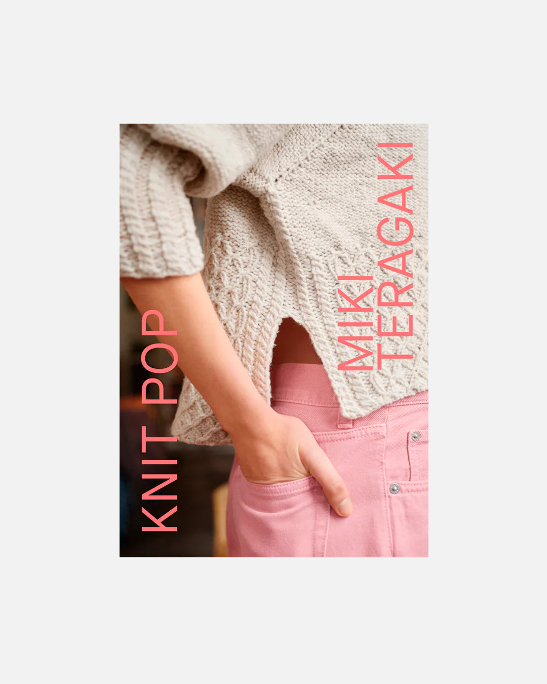 Book cover of "Knit Pop" featuring a close-up of a person wearing a white cable knit sweater and pink pants on a white background.