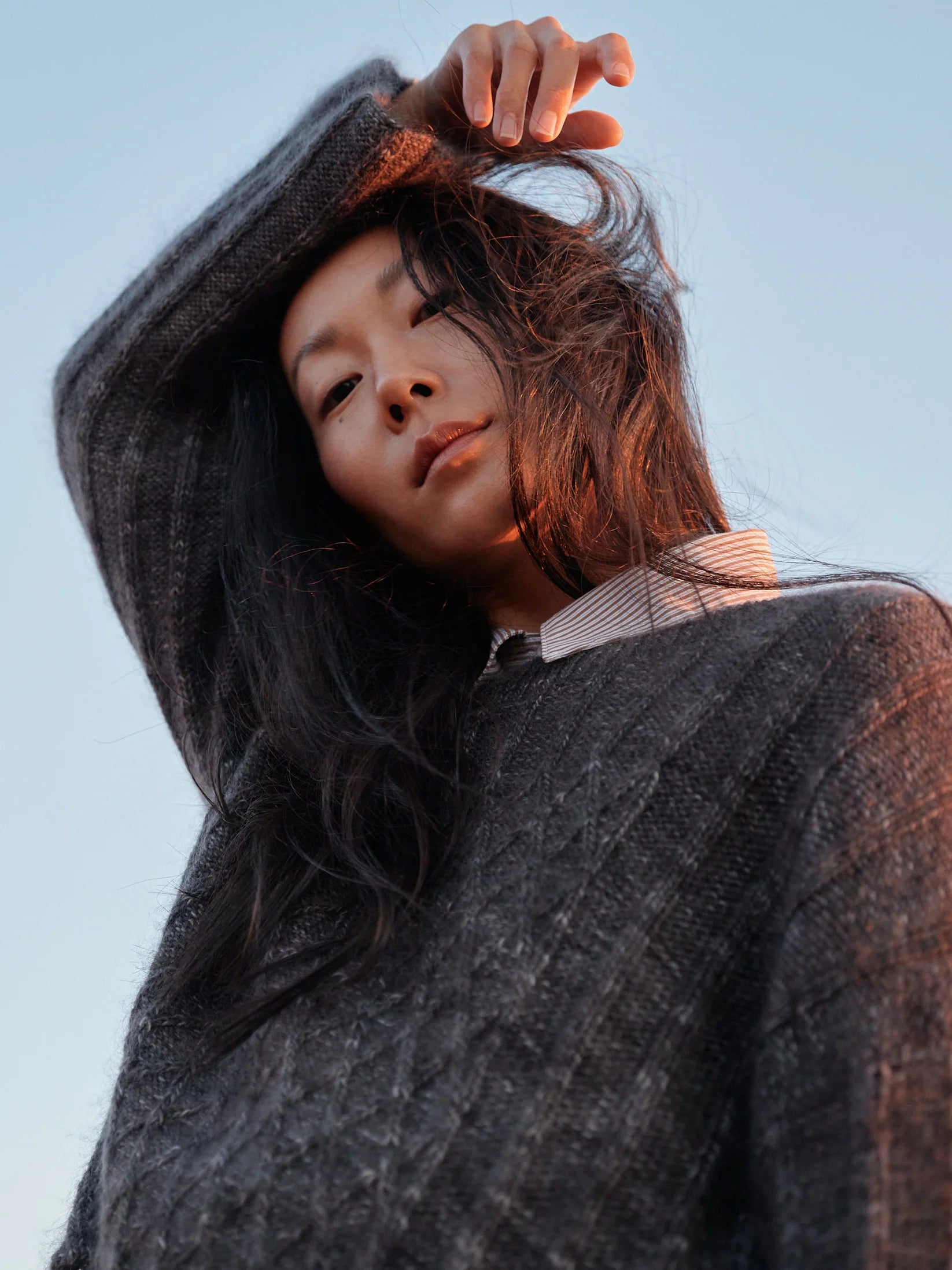 A person wearing a gray knit sweater.